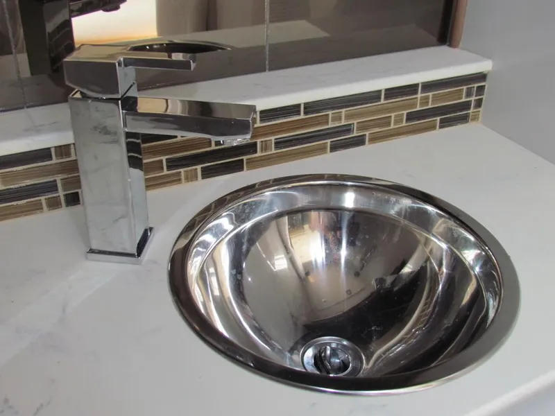 Slide: The Image of Modern chrome sink and faucet in 2020 Cruisers Yachts 35 Express bathroom. - 29