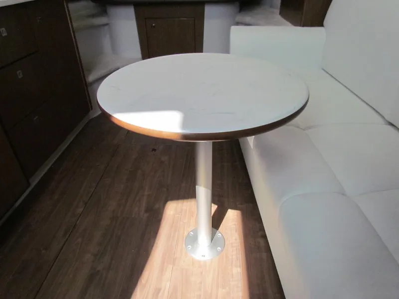 Slide: The Image of Interior of 2020 Cruisers Yachts 35 Express with round table and white seating. - 30