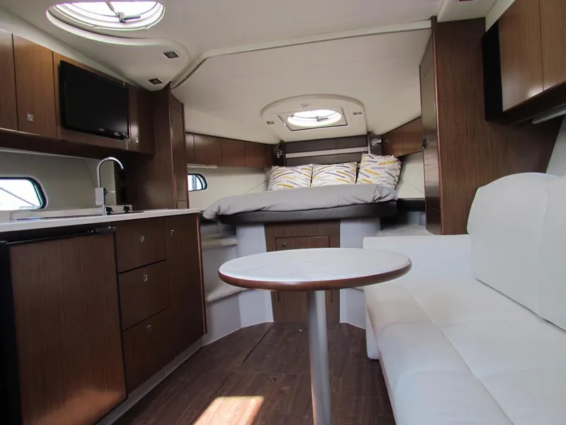 Slide: The Image of Interior of 2020 Cruisers Yachts 35 Express, featuring modern kitchen and cozy sleeping area. - 32
