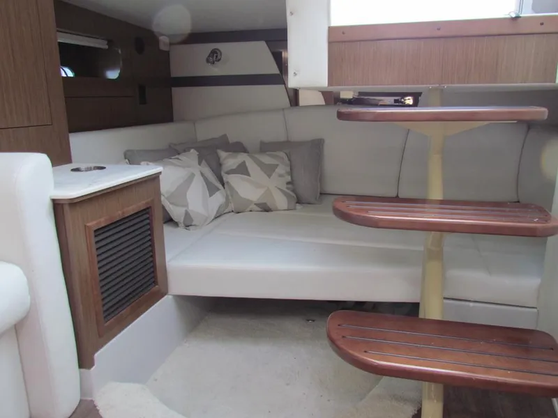 Slide: The Image of Interior of 2020 Cruisers Yachts 35 Express, featuring cozy seating and wooden steps. - 34