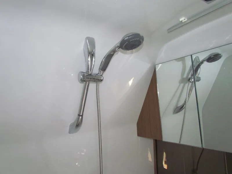 Slide: The Image of Shower area in 2020 Cruisers Yachts 35 Express, featuring modern chrome fixtures. - 40