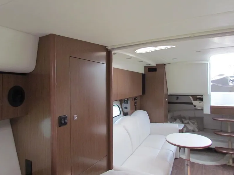 Slide: The Image of Interior of 2020 Cruisers Yachts 35 Express, featuring modern wood paneling and white seating. - 41