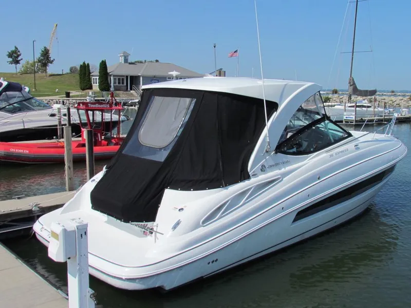 Slide: The Image of 2020 Cruisers Yachts 35 Express docked at marina, featuring sleek design and black canopy. - 42