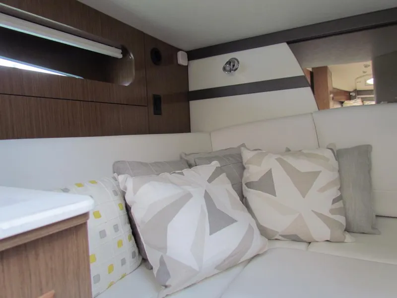 Slide: The Image of Interior of 2020 Cruisers Yachts 35 Express with modern cushions and wood paneling. - 44