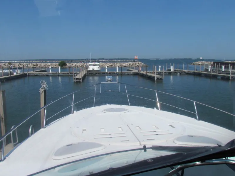 Slide: The Image of Cruisers Yachts 35 Express 2020 navigating marina with clear blue sky. - 45