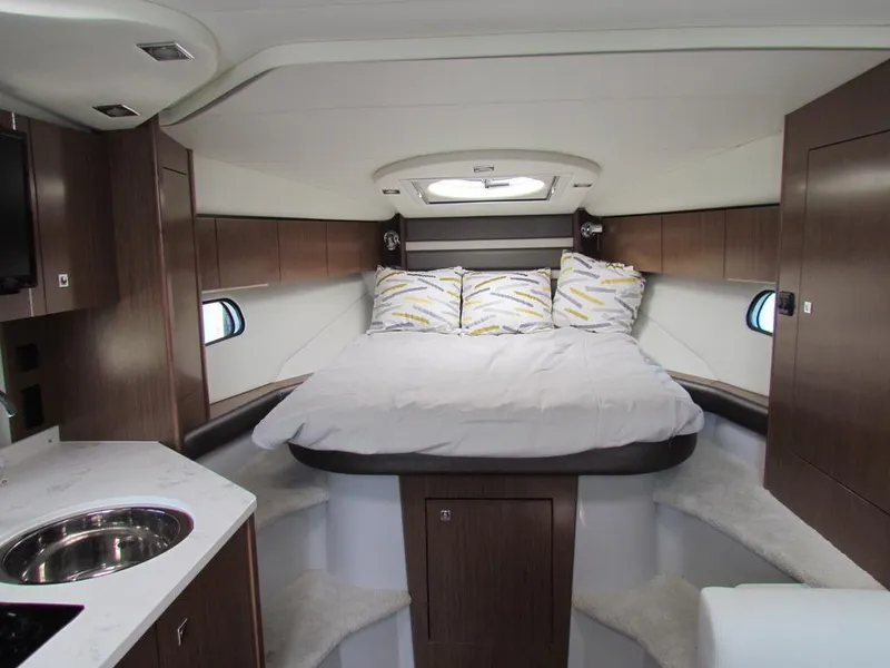Slide: The Image of Interior of 2020 Cruisers Yachts 35 Express, featuring a cozy bed and modern design. - 49