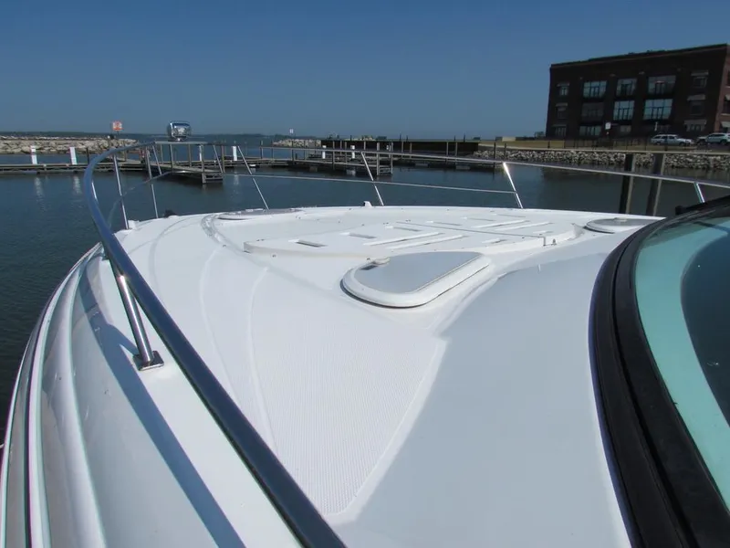 Slide: The Image of 2020 Cruisers Yachts 35 Express boat docked at marina, clear sky background. - 7