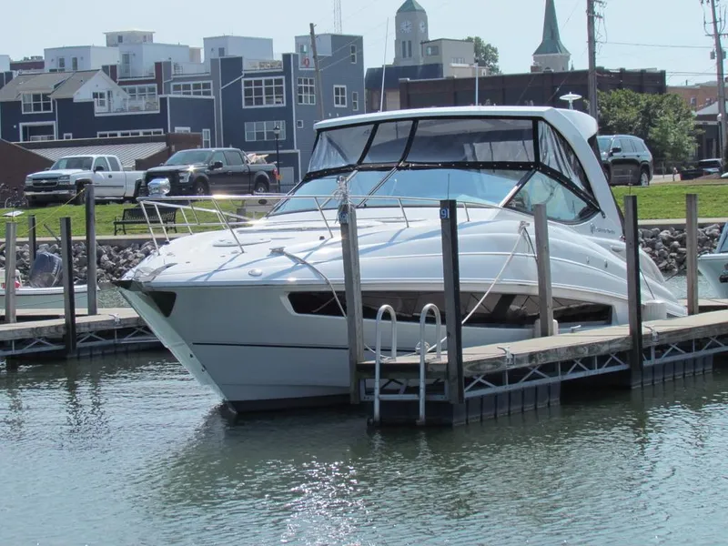 Slide: The Image of 2020 Cruisers Yachts 35 Express docked at marina, urban backdrop. - 8