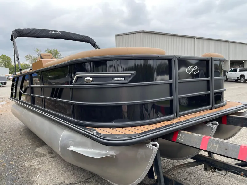 Slide: The Image of 2025 Bentley Pontoons Elite 223 Admiral, black exterior, docked on trailer. - 2