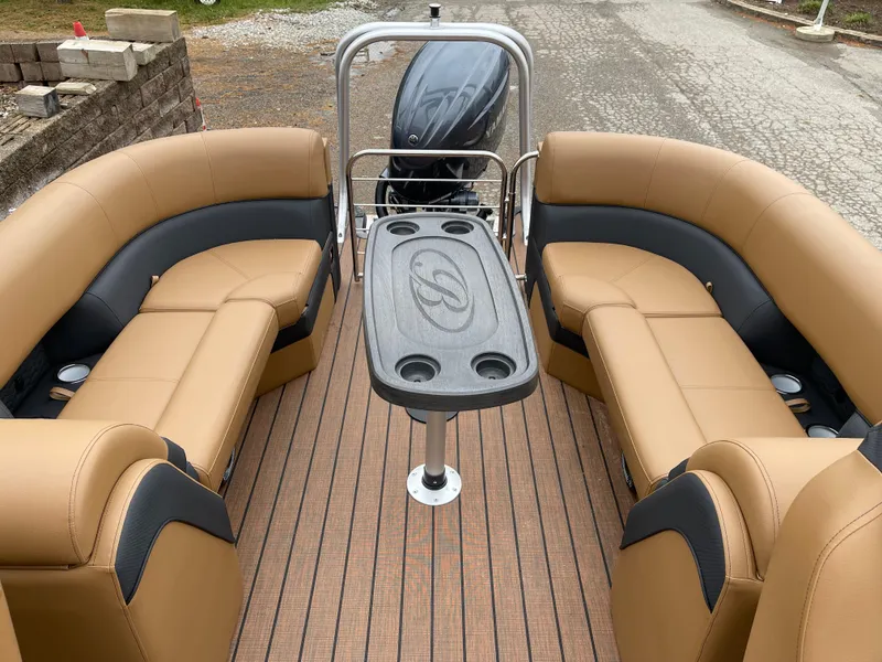 Slide: The Image of 2025 Bentley Pontoons Elite 223 Admiral interior with tan seating and central table. - 9