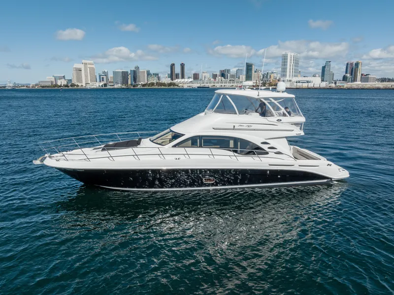 Slide: The Image of 2005 Sea Ray 550 Sedan Bridge yacht cruising near city skyline. - 0