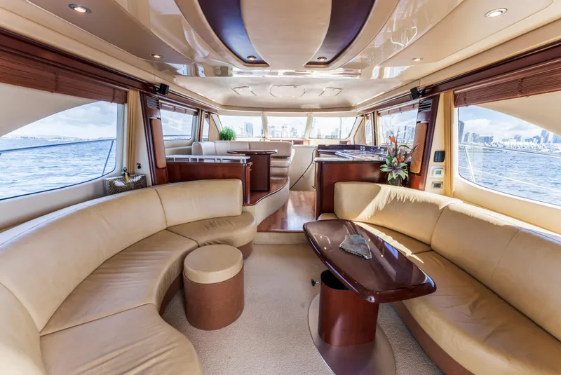 Slide: The Image of Luxurious interior of 2005 Sea Ray 550 Sedan Bridge yacht with elegant seating and panoramic windows. - 11