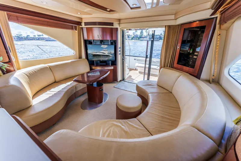 Slide: The Image of Luxurious interior of 2005 Sea Ray 550 Sedan Bridge yacht with curved seating and scenic views. - 12