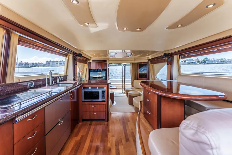 Slide: The Image of Luxurious interior of 2005 Sea Ray 550 Sedan Bridge yacht with modern kitchen and seating. - 14