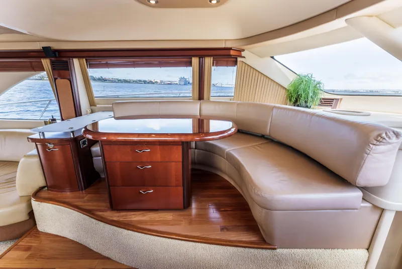 Slide: The Image of Luxurious interior of 2005 Sea Ray 550 Sedan Bridge yacht with leather seating and wooden table. - 15
