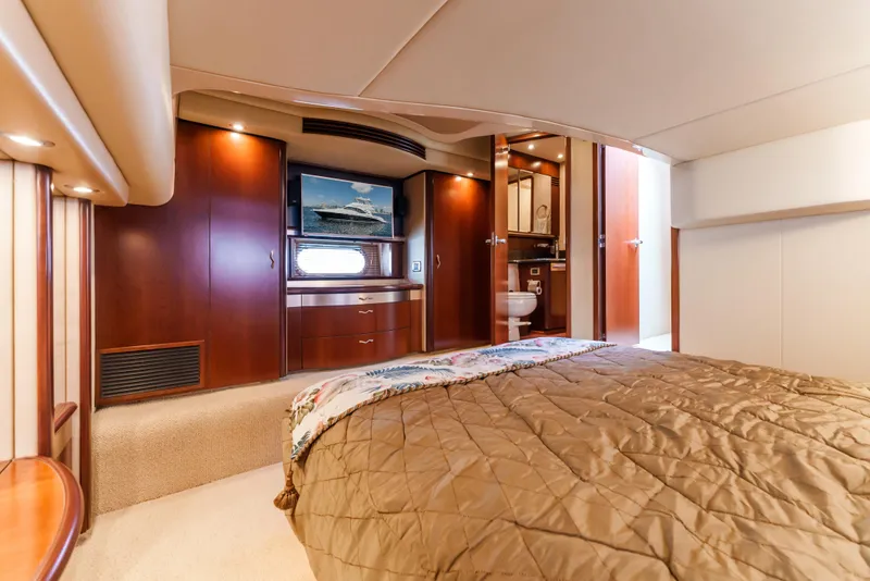 Slide: The Image of Luxurious 2005 Sea Ray 550 Sedan Bridge yacht interior with cozy bedroom and elegant wood finishes. - 17