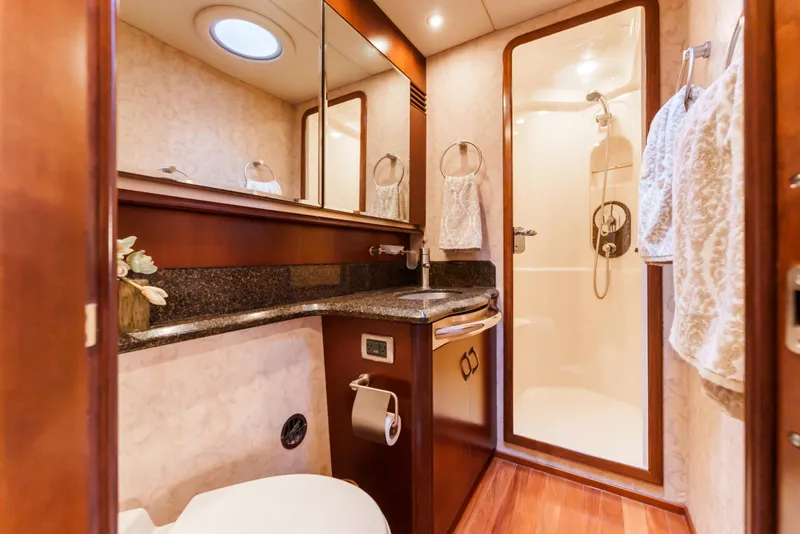 Slide: The Image of Luxurious bathroom in 2005 Sea Ray 550 Sedan Bridge yacht with shower and wood accents. - 18