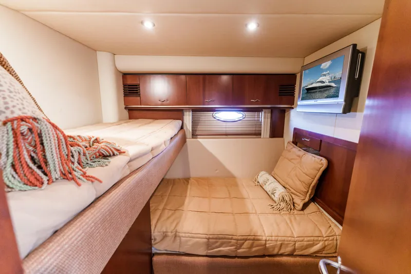 Slide: The Image of Luxurious cabin interior of 2005 Sea Ray 550 Sedan Bridge yacht with cozy bedding. - 19