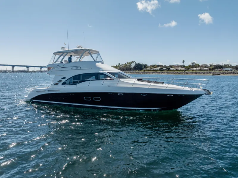 Slide: The Image of 2005 Sea Ray 550 Sedan Bridge yacht cruising on open water. - 2