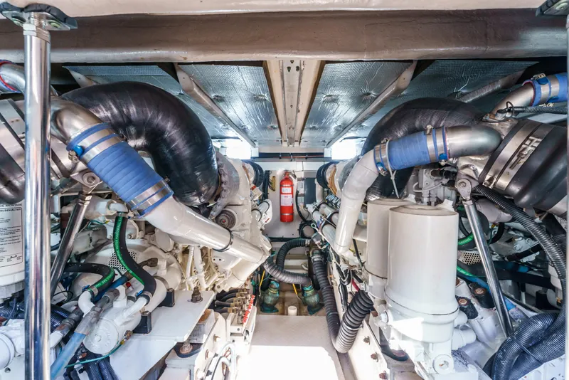 Slide: The Image of Engine room of 2005 Sea Ray 550 Sedan Bridge with visible machinery and fire extinguisher. - 24