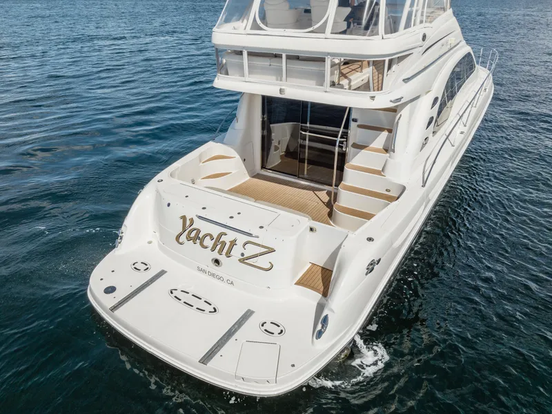 Slide: The Image of 2005 Sea Ray 550 Sedan Bridge yacht on water, rear view, elegant design. - 3