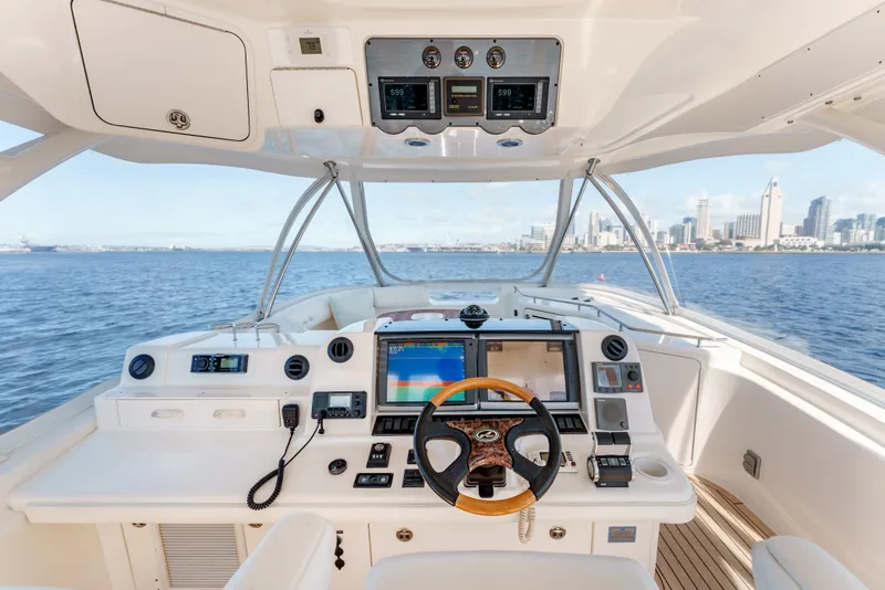 Slide: The Image of Helm of 2005 Sea Ray 550 Sedan Bridge yacht with city skyline view. - 6