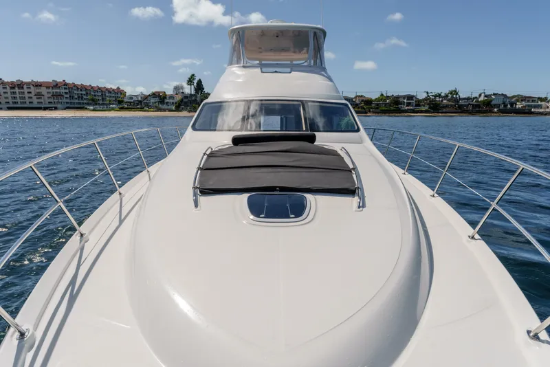 Slide: The Image of 2005 Sea Ray 550 Sedan Bridge yacht on calm water, clear sky background. - 8