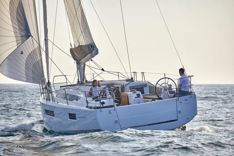 Slide: The Image of 2025 Jeanneau Sun Odyssey 410 sailing on open water, showcasing sleek design and performance. - 22