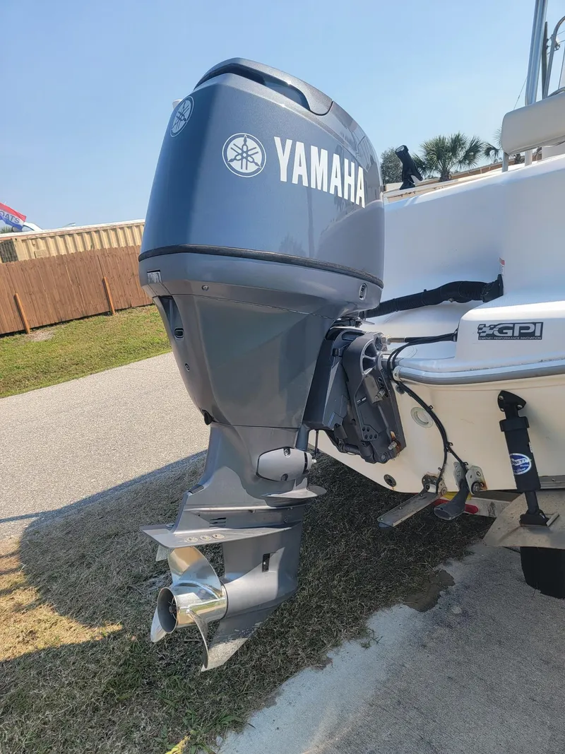 Slide: The Image of Yamaha outboard motor on a 2006 Wellcraft 180 Fisherman boat, parked on grass. - 6