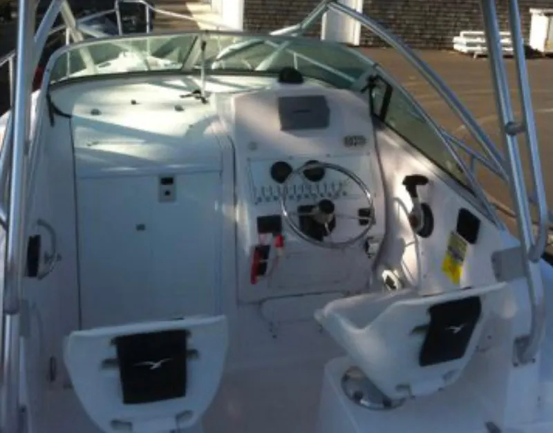 Slide: The Image of 2006 Pro-Line 24 Walk boat cockpit with steering wheel and seating. - 10