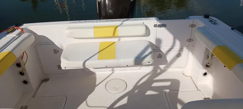Slide: The Image of 2006 Pro-Line 24 Walk boat interior with yellow-accented seating and storage compartments. - 11