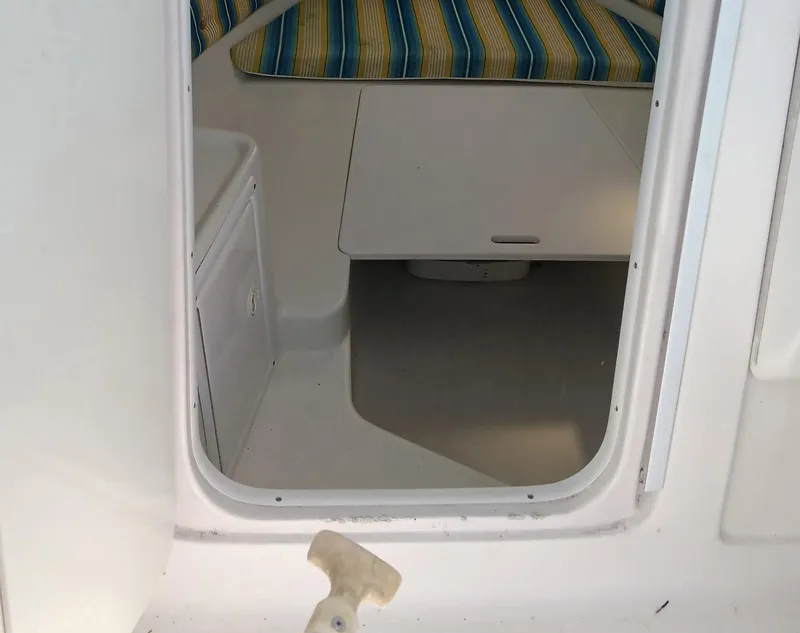 Slide: The Image of 2006 Pro-Line 24 Walk cabin interior with striped cushions and compact table. - 7