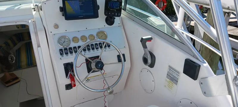 Slide: The Image of 2006 Pro-Line 24 Walk boat dashboard with steering wheel and navigation equipment. - 8