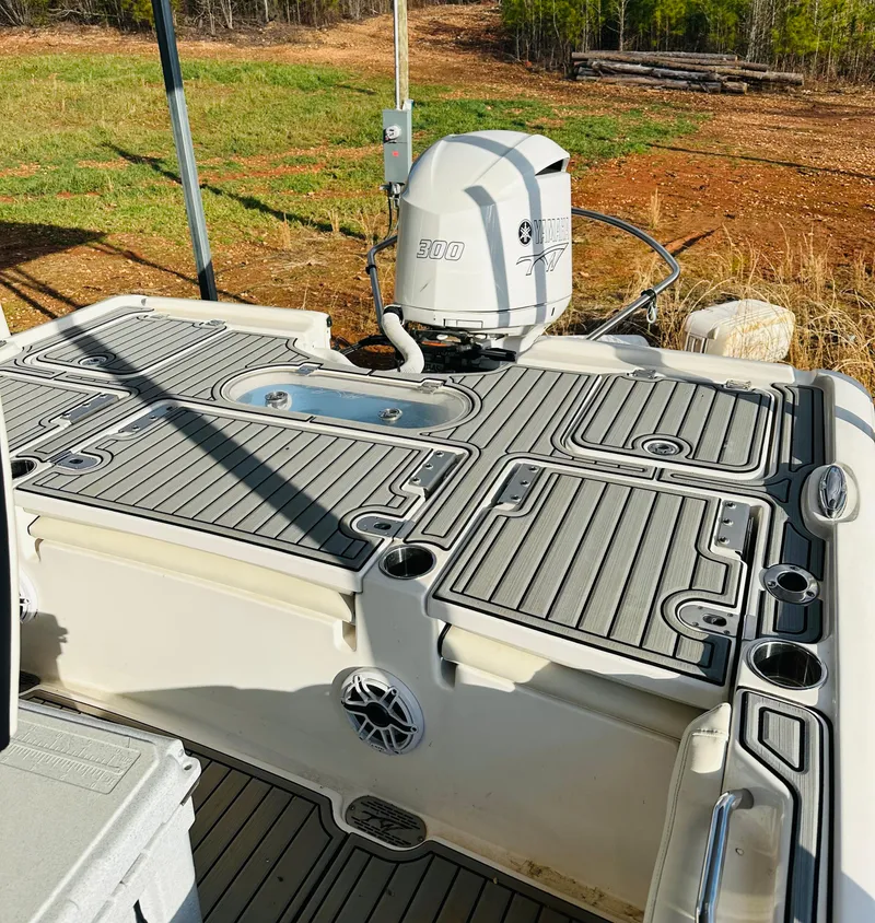 Slide: The Image of 2021 Tidewater 2500 Carolina Bay boat deck with Yamaha engine, featuring non-slip flooring. - 11