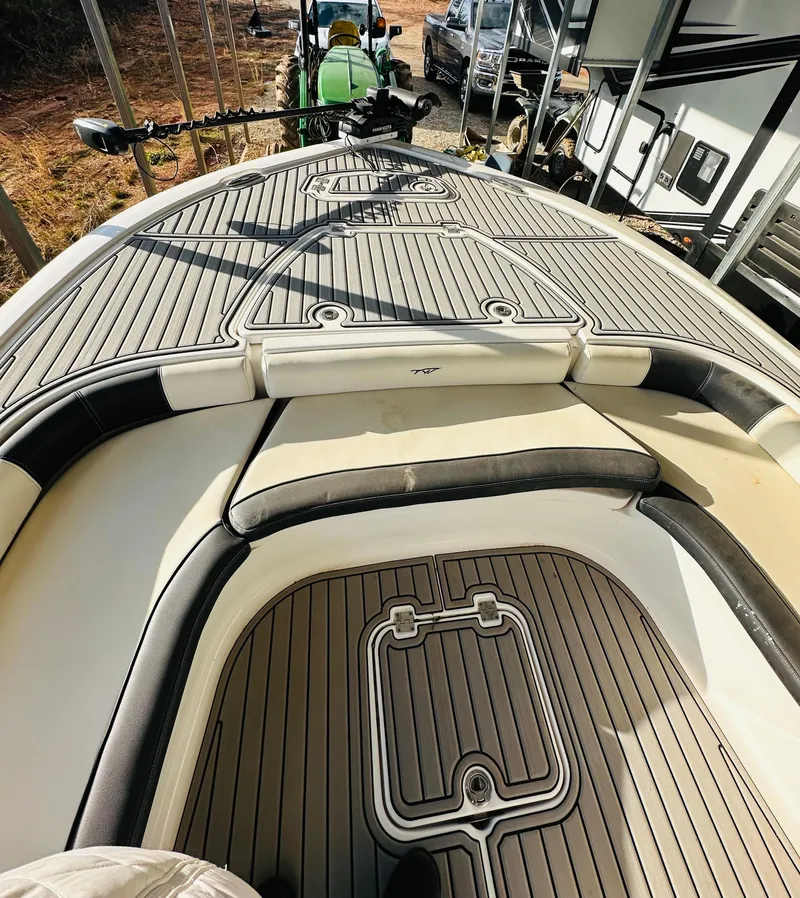 Slide: The Image of 2021 Tidewater 2500 Carolina Bay boat deck with cushioned seating and storage compartments. - 12