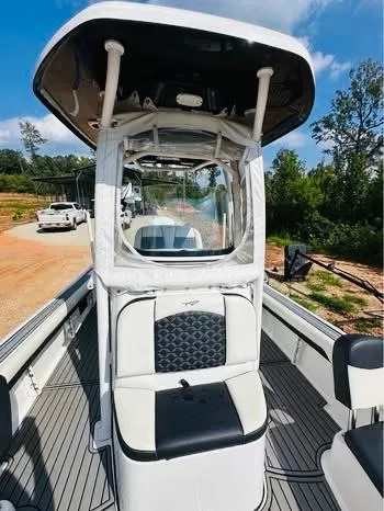 Slide: The Image of 2021 Tidewater 2500 Carolina Bay boat with center console and seating, outdoors. - 15