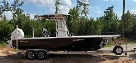 Slide: The Image of 2021 Tidewater 2500 Carolina Bay boat on trailer, parked outdoors. - 2
