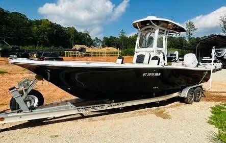 Slide: The Image of 2021 Tidewater 2500 Carolina Bay boat on trailer, parked outdoors under blue sky. - 3