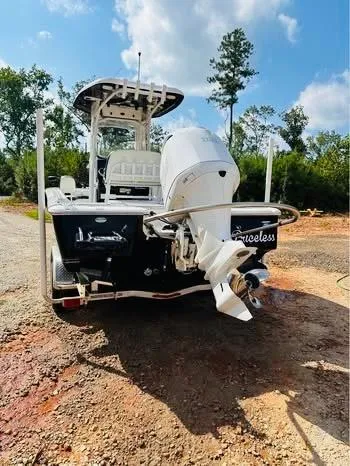 Slide: The Image of 2021 Tidewater 2500 Carolina Bay boat, rear view, parked outdoors on a sunny day. - 4