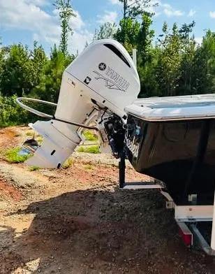 Slide: The Image of 2021 Tidewater 2500 Carolina Bay boat with Yamaha outboard motor, parked outdoors. - 5