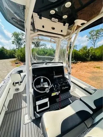 Slide: The Image of 2021 Tidewater 2500 Carolina Bay boat interior with steering wheel and seating. - 6