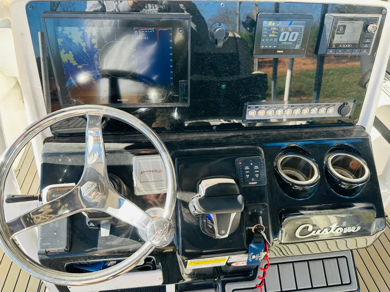 Slide: The Image of Control panel of 2021 Tidewater 2500 Carolina Bay boat with steering wheel and navigation screens. - 9