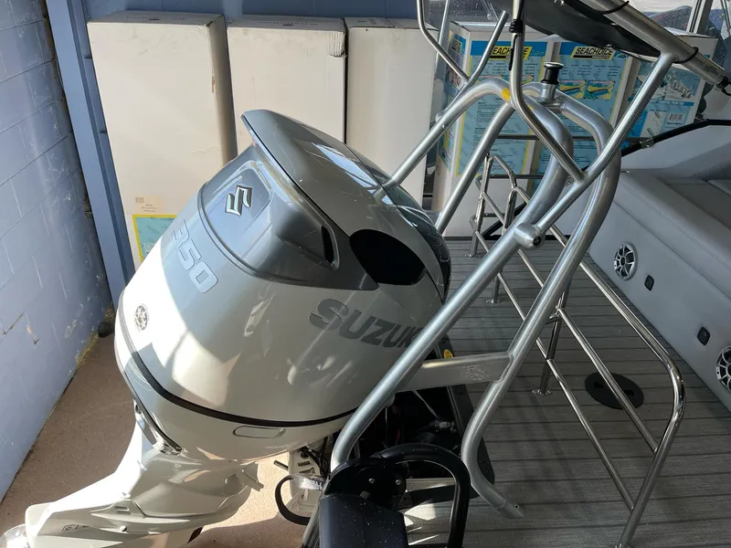 Slide: The Image of 2025 Bentley Pontoons Elite 253 Swingback with Suzuki outboard motor, docked indoors. - 13