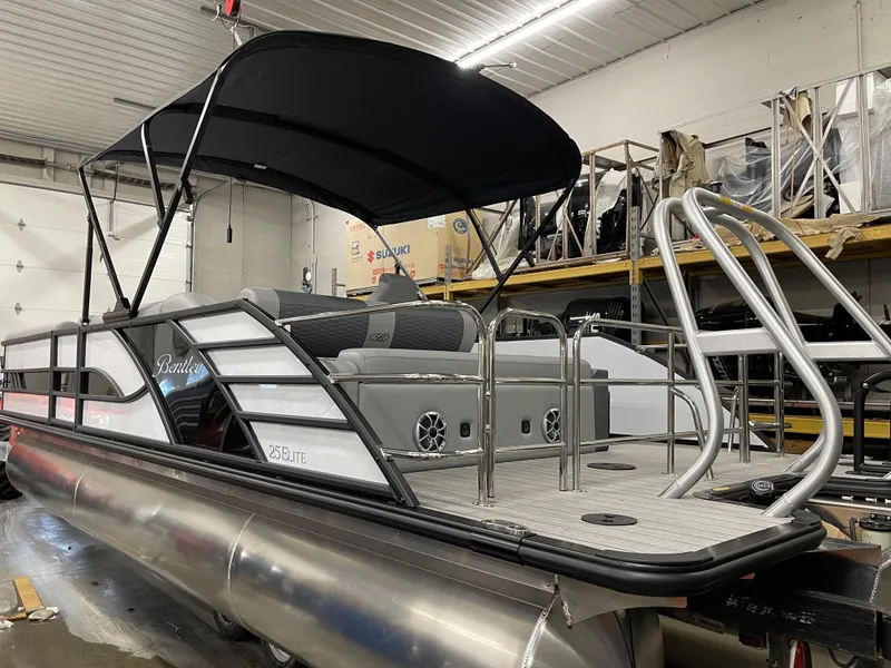 Slide: The Image of 2025 Bentley Pontoons Elite 253 Swingback in a showroom, featuring sleek design and modern amenities. - 4