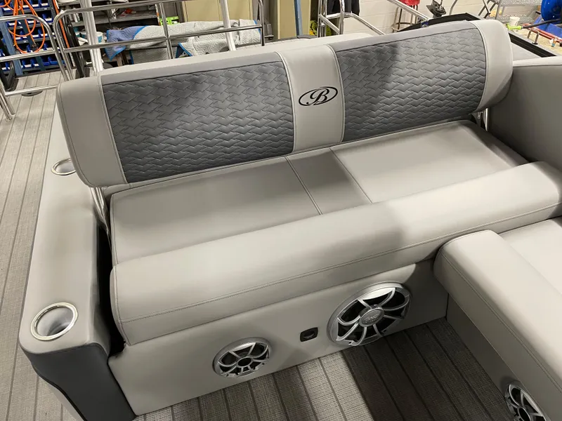 Slide: The Image of 2025 Bentley Pontoons Elite 253 Swingback interior seating with speakers and cup holders. - 5