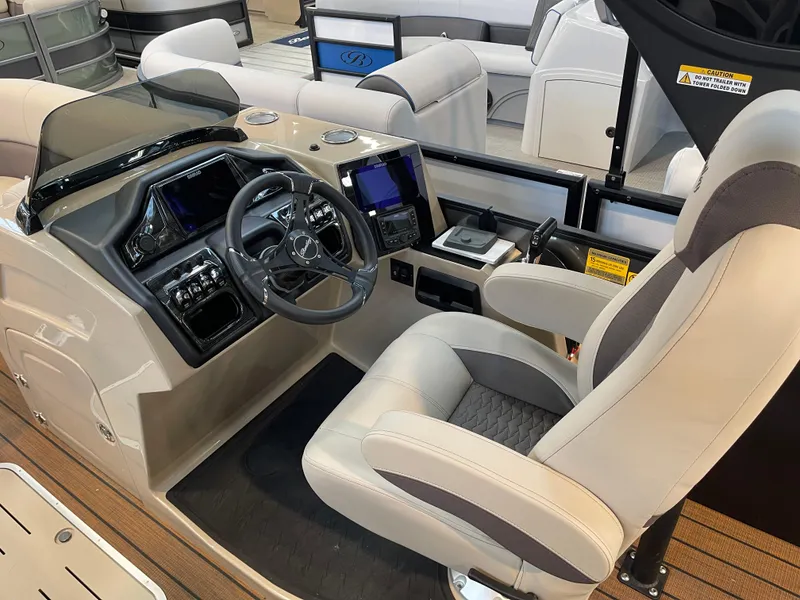 Slide: The Image of 2025 Bentley Pontoons Elite 223 Swingback Tower interior with modern helm and seating. - 3