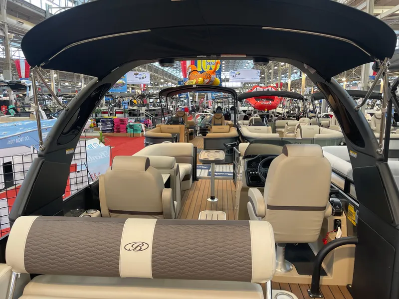 Slide: The Image of 2025 Bentley Pontoons Elite 223 Swingback Tower interior at a boat show. - 4