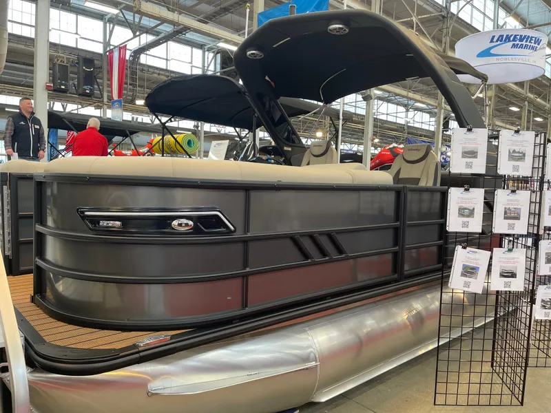 Slide: The Image of 2025 Bentley Pontoons Elite 223 Swingback Tower displayed at a boat show. - 5