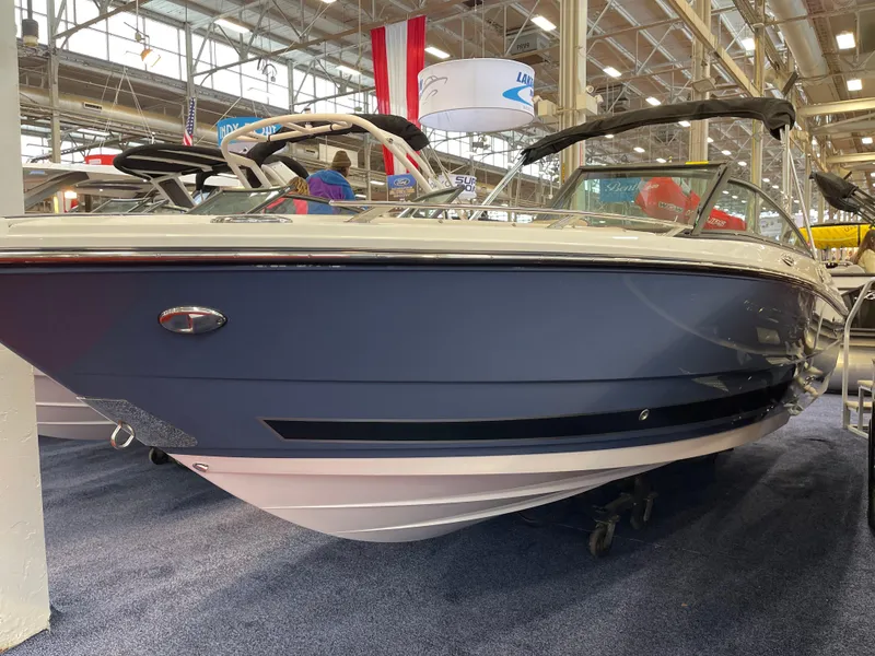 The Image of 2025 Monterey 218 SS boat displayed indoors at a boat show. - 1