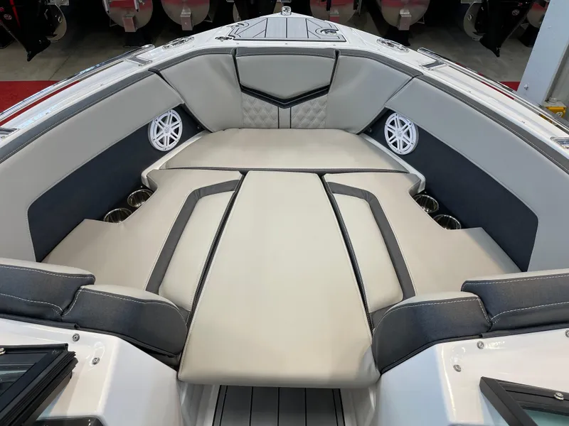 Slide: The Image of 2025 Monterey 218 SS boat interior with cushioned seating and built-in speakers. - 10